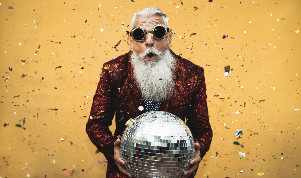 Elderly man holding a disco ball